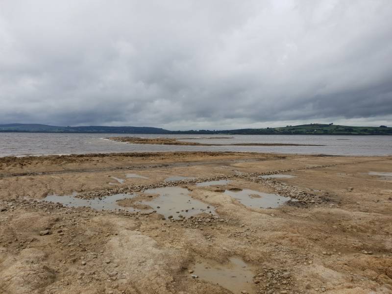 View SW over old road under lake